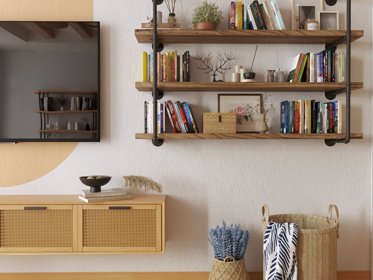 PIPE 60 inch bracket shelf with burnt boards styled with books and plants in a living room