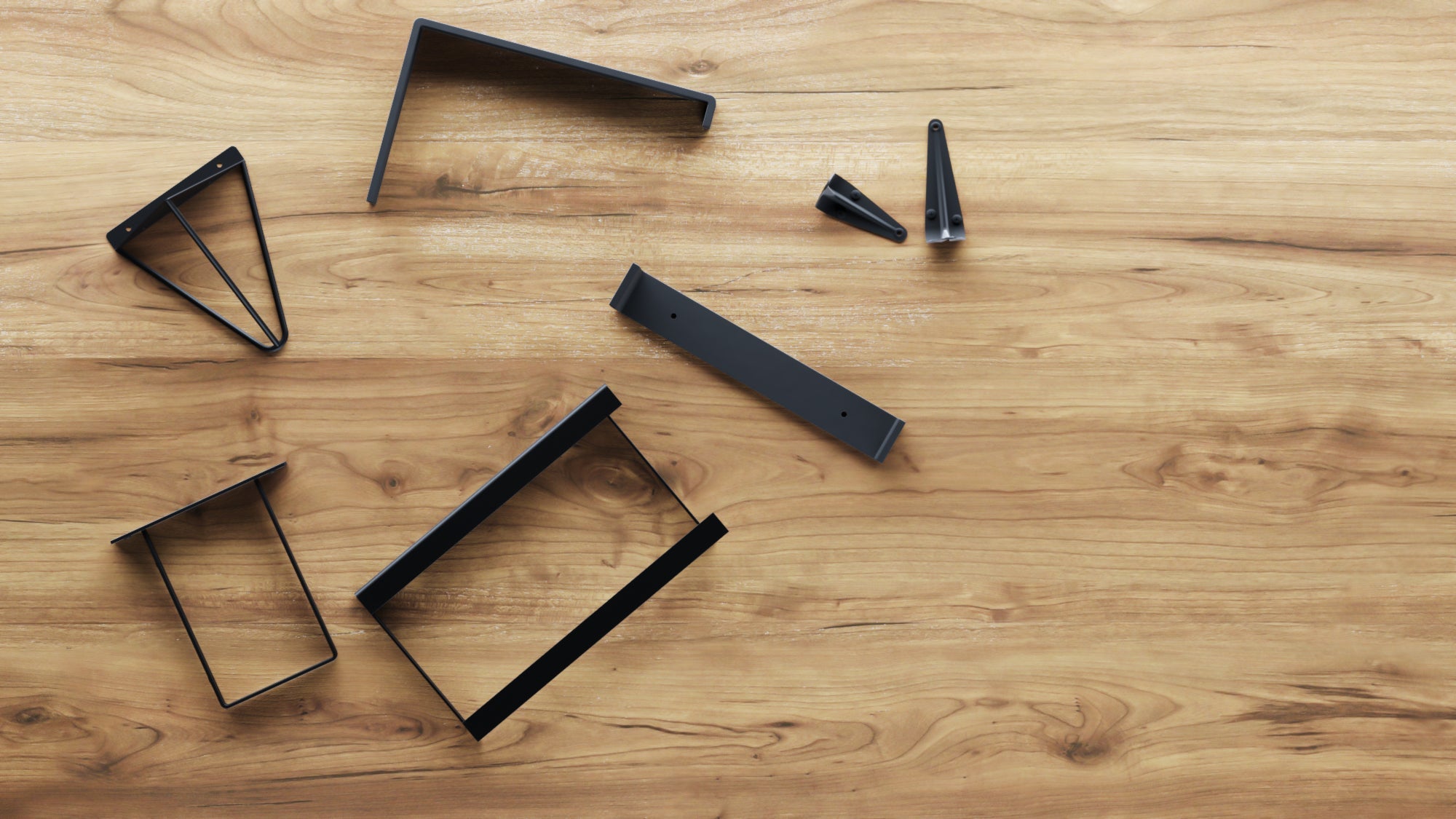 A variety of heavy duty shelving brackets randomly placed on walnut wood desktop