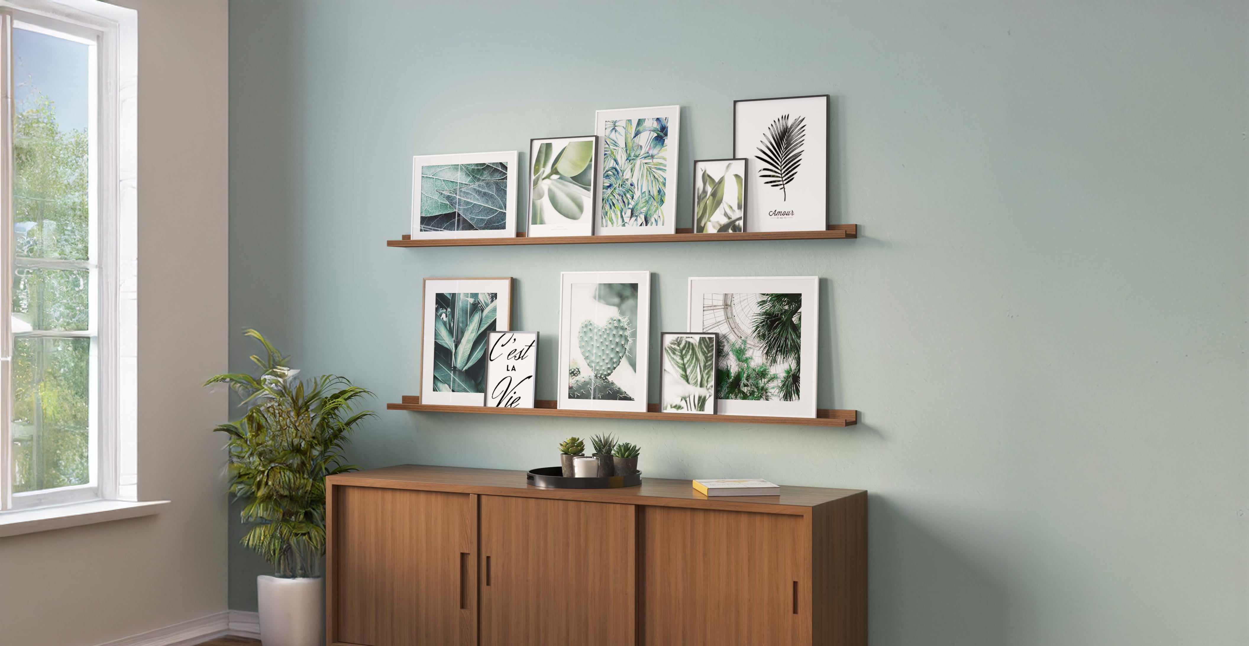 A cozy living room with a gray sofa adorned with cushions. Above it, three long floating shelves for wall natural display a variety of framed photographs, creating a personal and inviting atmosphere.