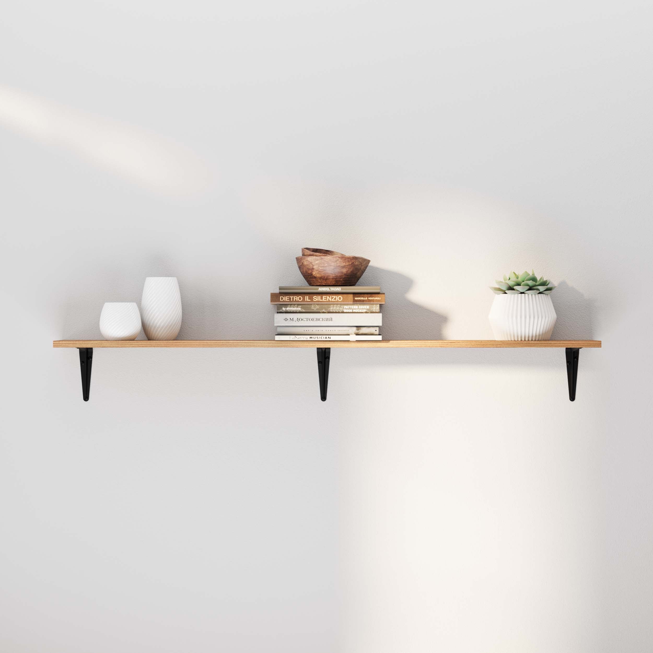 A simple floating shelf with black brackets, styled with books, vases, and a succulent. Clean lines and soft lighting enhance its minimalist charm.