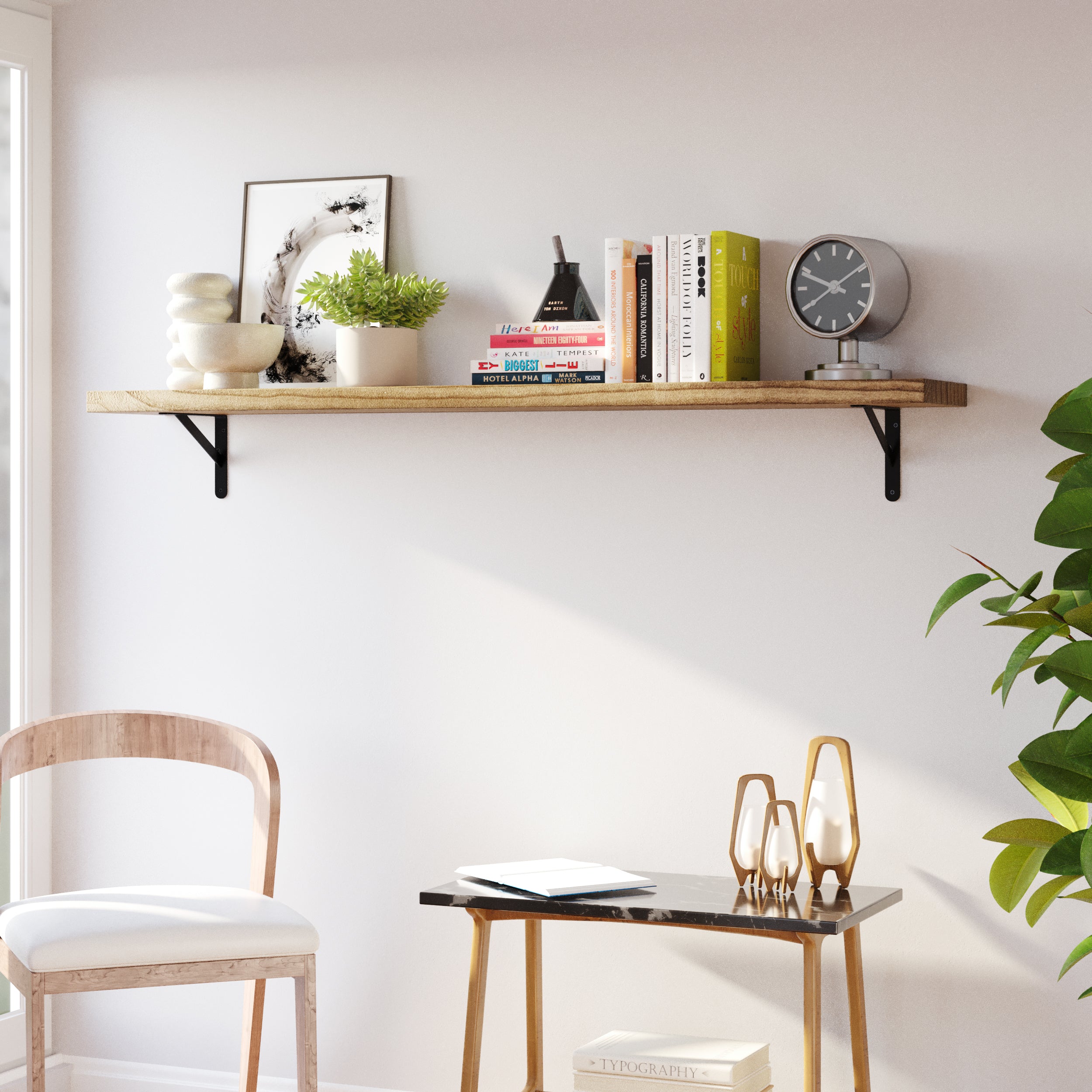 A 60 inch wooden boho shelf mounted on a wall, showcasing curated books, a clock, and small plants, complemented by a sleek marble table and minimalist decor.