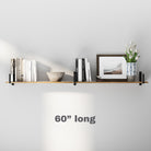 A 6 inch long floating book shelf with black metal brackets, holding books, a framed picture, a decorative bowl, and a vase with white tulips, blending minimalist and modern styles.