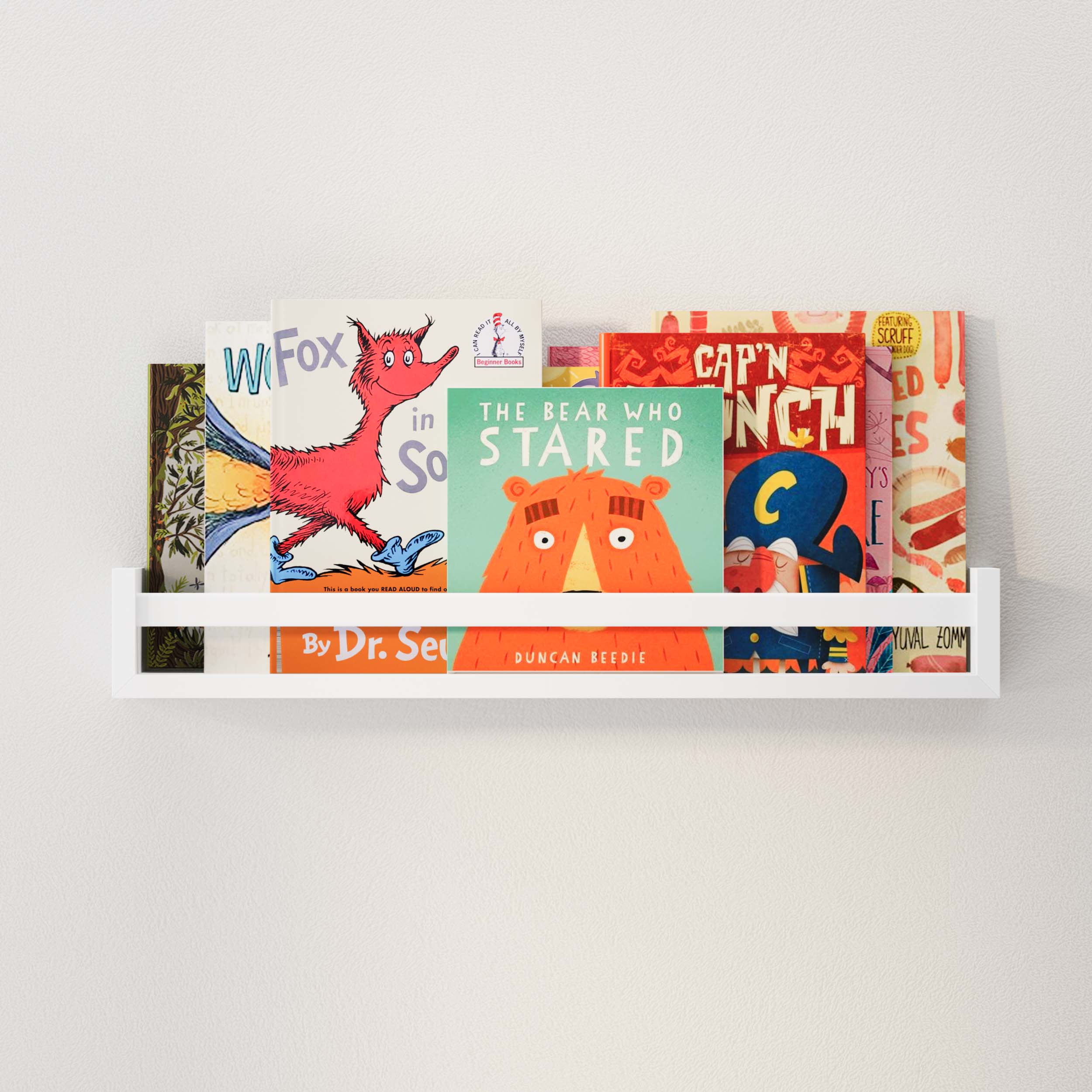 A single white kids shelf on a plain wall, filled with colorful children's books, showcasing a neat and organized display that is perfect for a child's bedroom or playroom.