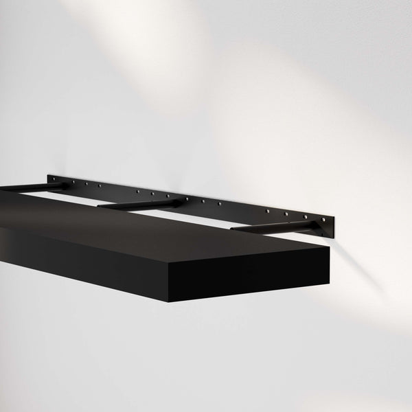 Close-up of a floating shelf for wall black mounted on the wall, highlighting its sleek design and sturdy brackets.