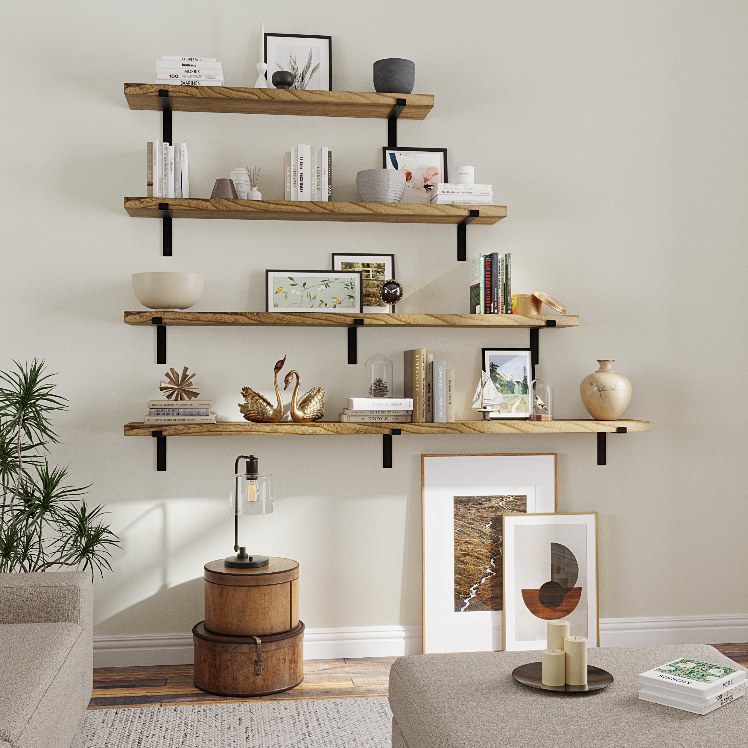 A set of four wooden floating shelves with black brackets, styled with books, vases, plants, and gold swan figurines in a cozy living space.