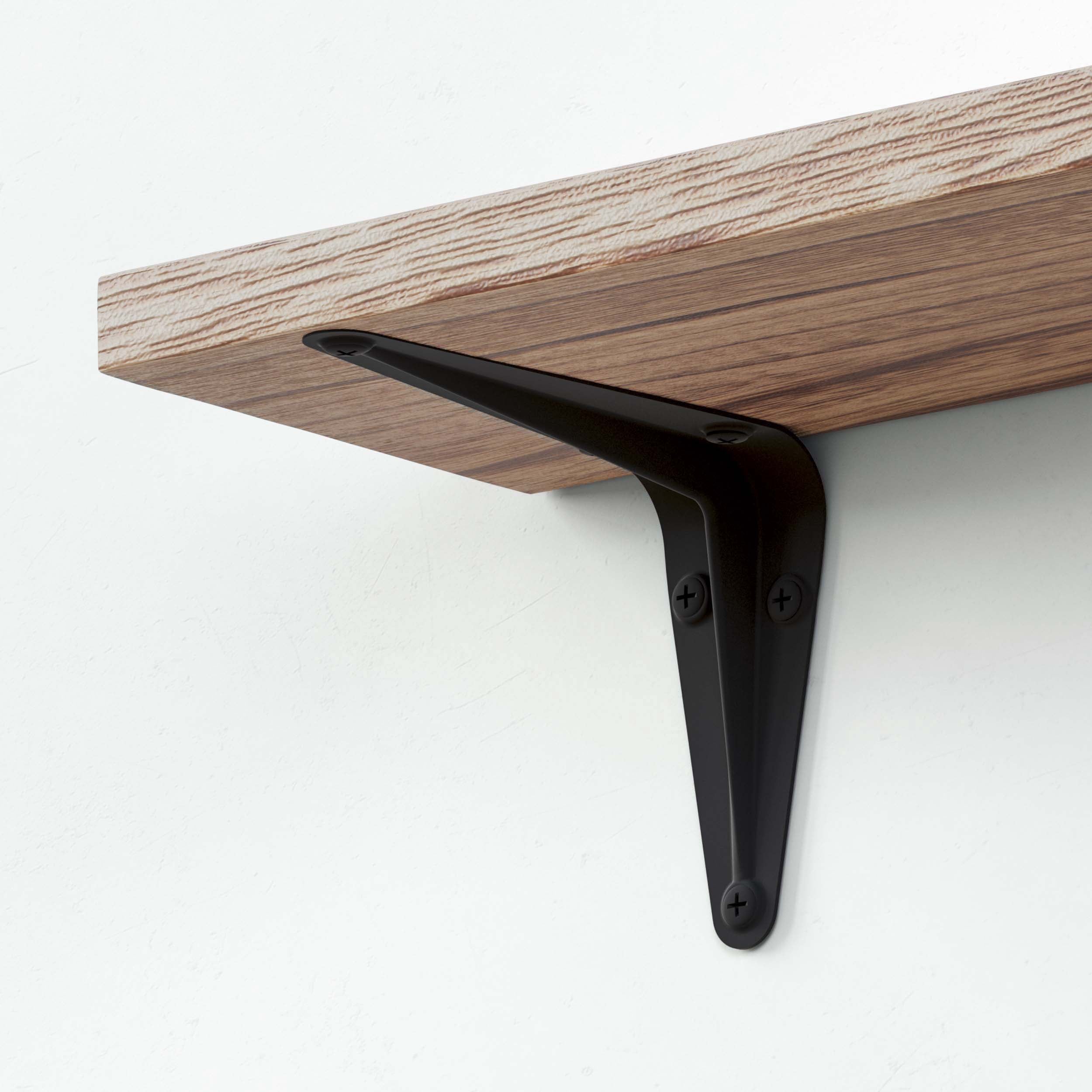 Close-up of a black industrial metal bracket securely supporting a wooden shelf for home organization.
