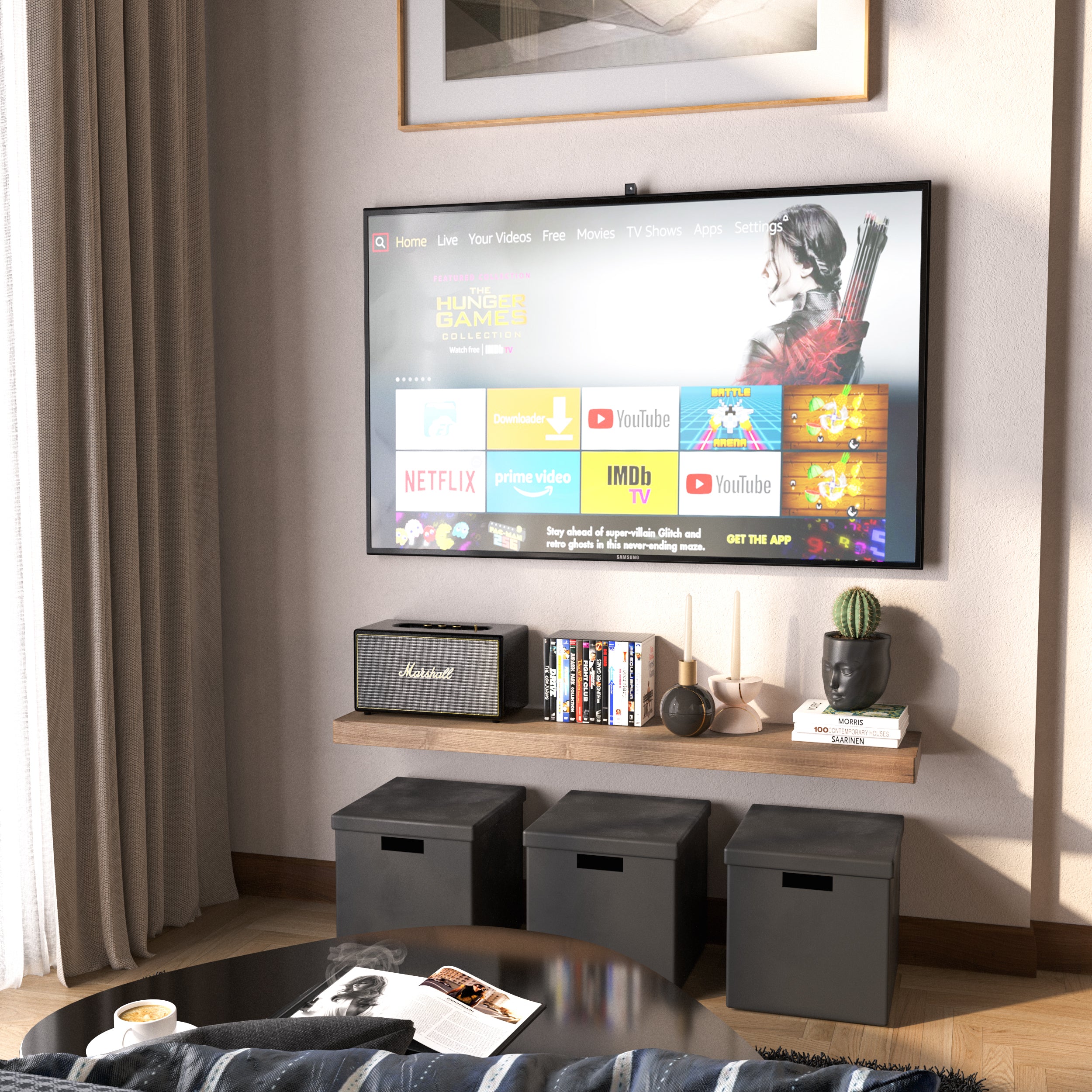 A wall mounted shelf with invisible bracket in a rich special walnut finish below a wall-mounted TV holds media items and decorative objects. Black cube storage and neutral tones complete the entertainment nook.