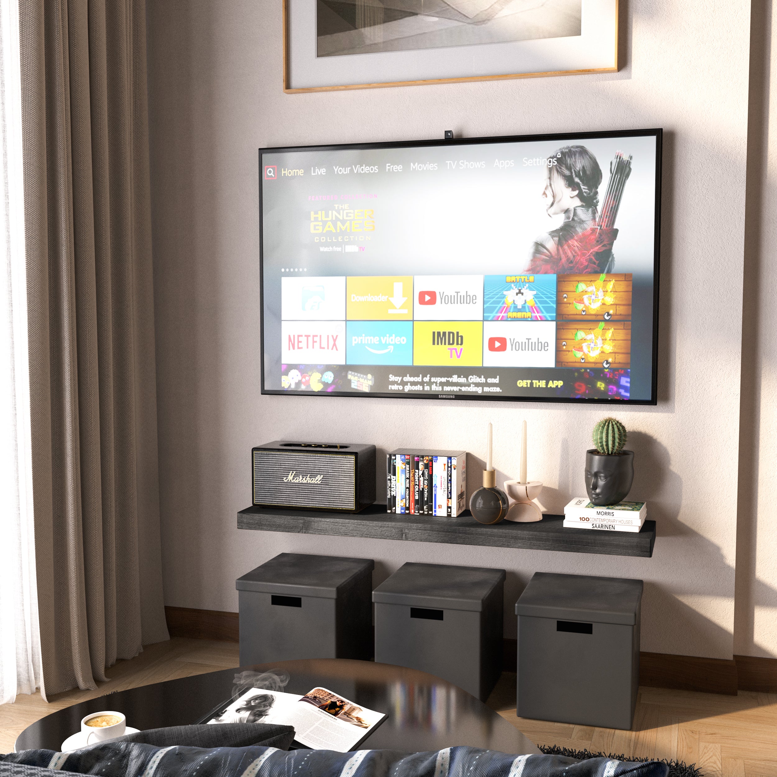 A 48 inch wall book shelf with hidden bracket in ebony finish below a wall-mounted TV holds media items and decorative objects. Black cube storage and neutral tones complete the entertainment nook.