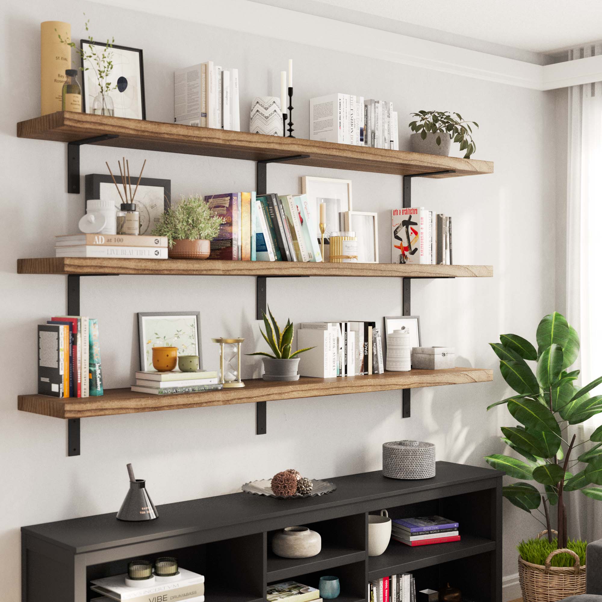 Three stacked 72" rustic shelves mounted on a living room wall, elegantly displaying books, plants, and modern decor, showcasing their large capacity for storage and decoration.