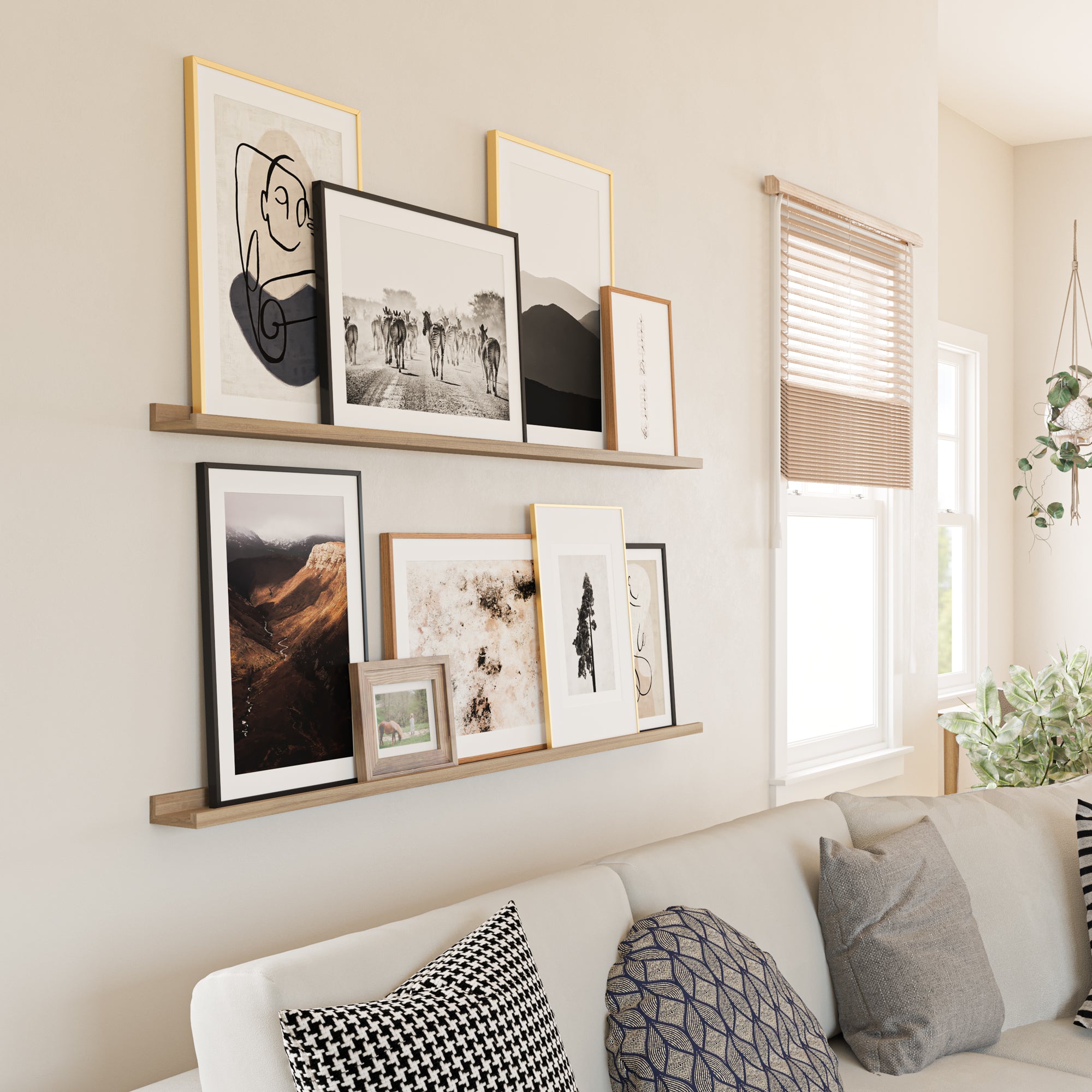 Elegant living space with a sofa adorned with patterned pillows, and wooden shelves above showcasing an array of framed art pieces.