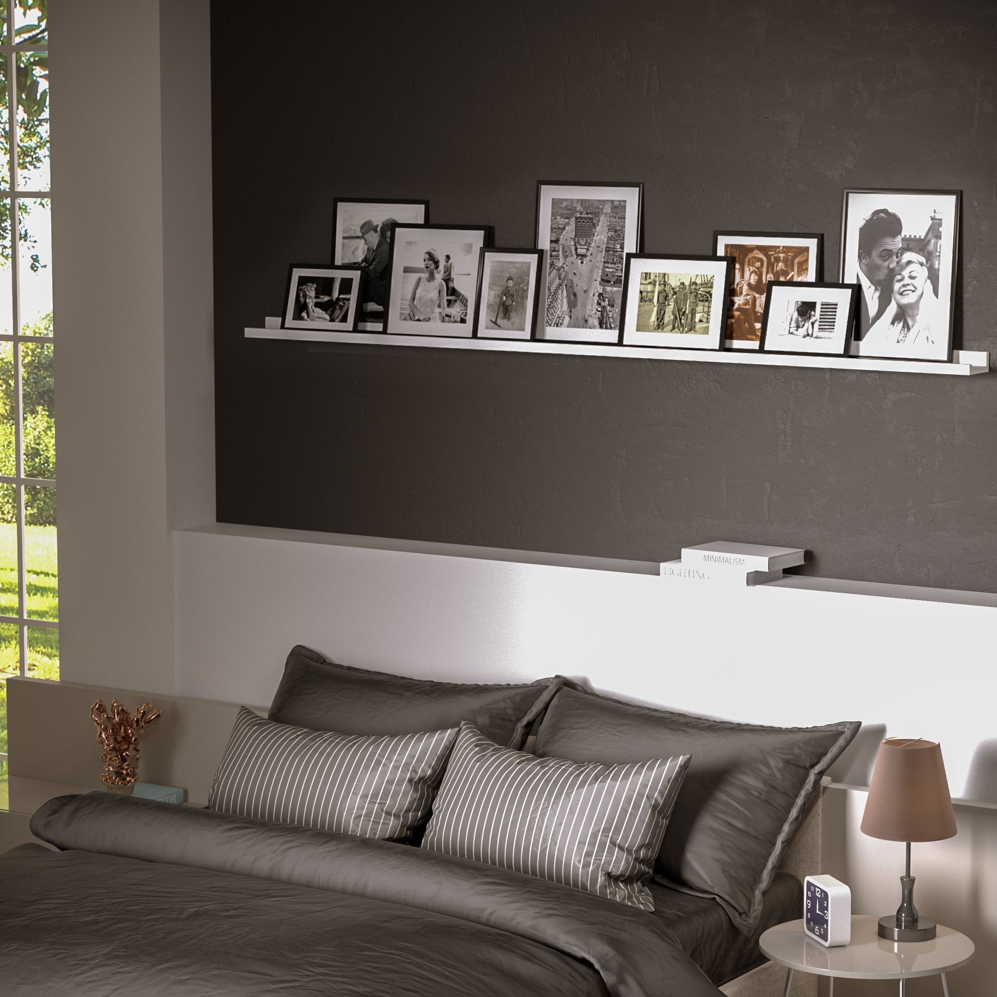 72 inch foating shelf with frames on a dark wall above a bed.