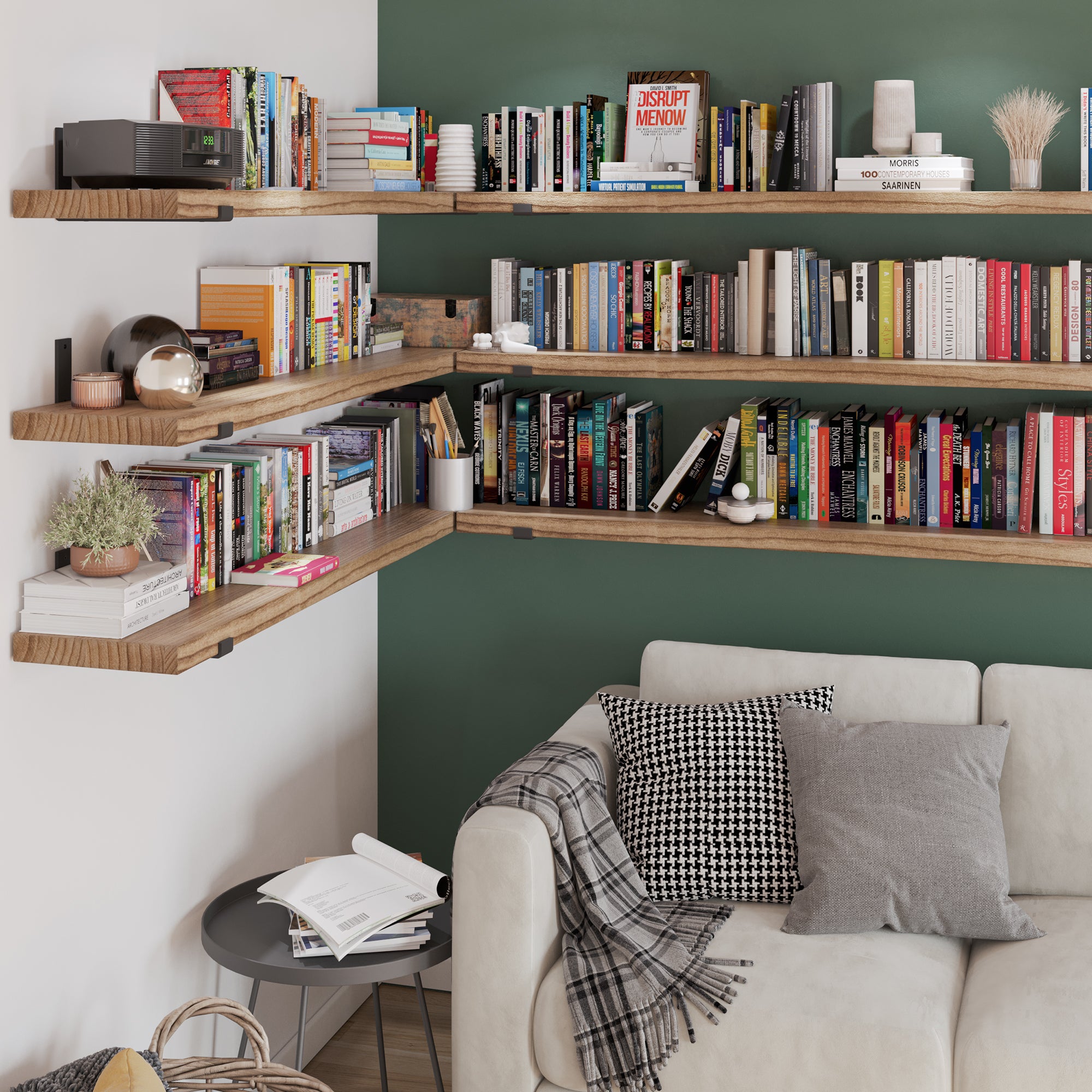 An L-shaped shelving setup on a green accent wall, filled with books and decor, creating a library-like ambiance in the cozy living room setting.