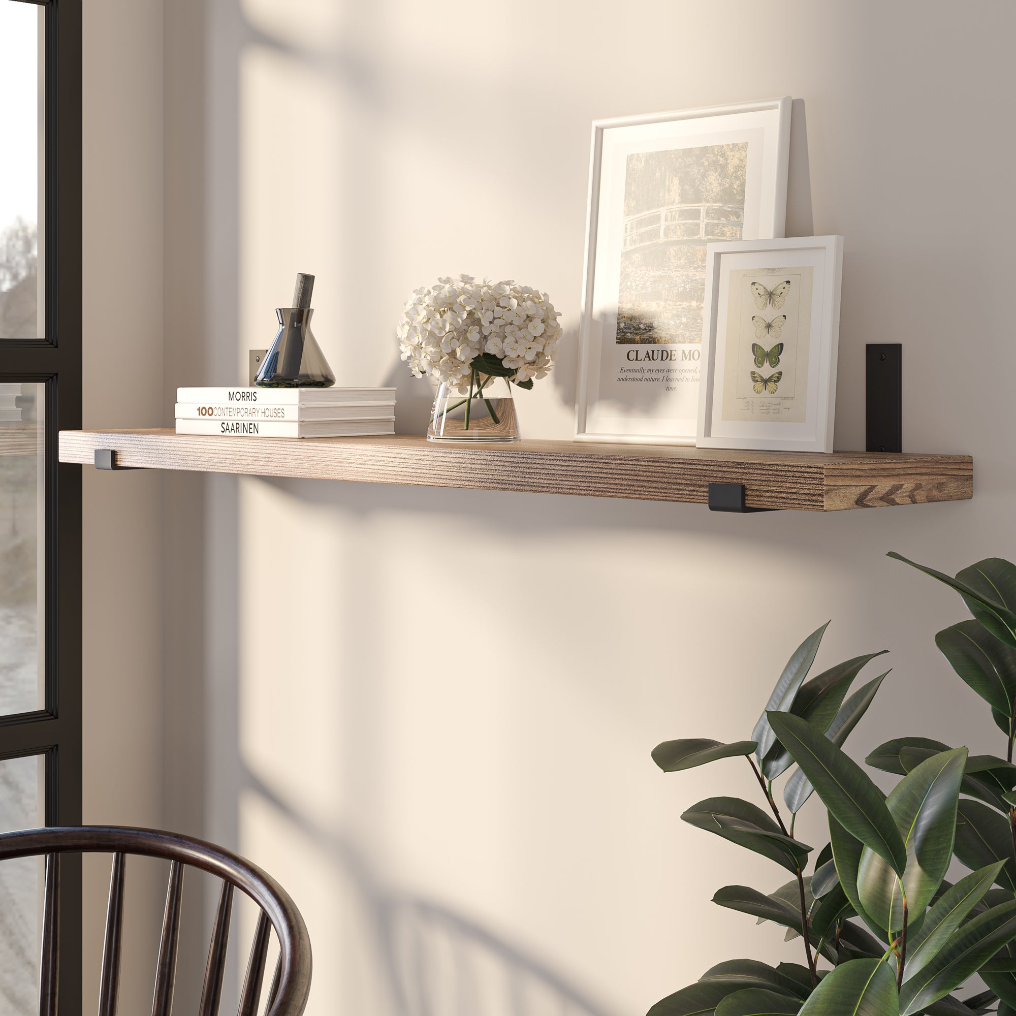 Display shelf with books and a floral arrangement by a window.