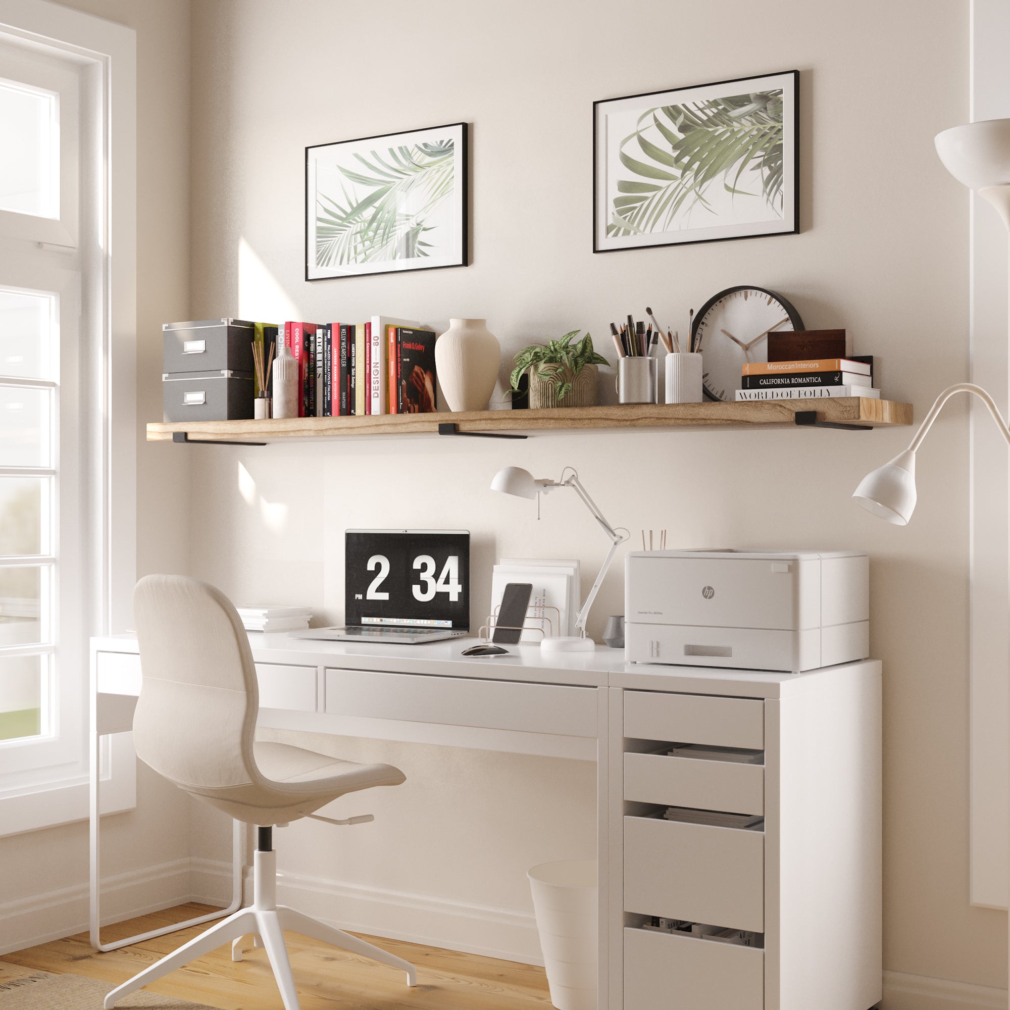A single wooden shelf over a black desk, styled with books, office supplies, and lush green plants, creating an organized workspace.