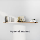 A minimalist 60 inch long floating shelf in special walnut color holding books, a clock, and neutral-toned décor against a light gray wall.
