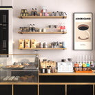 60 Inch long coffee bar shelves showcasing coffee bags, brewing tools, and glassware, paired with a vintage "Americano" poster.