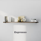 A floating wall bookshelf in an espresso finish holds neatly arranged books, a clock, decorative items, and a minimalist color scheme. The shelf is labeled "Espresso."