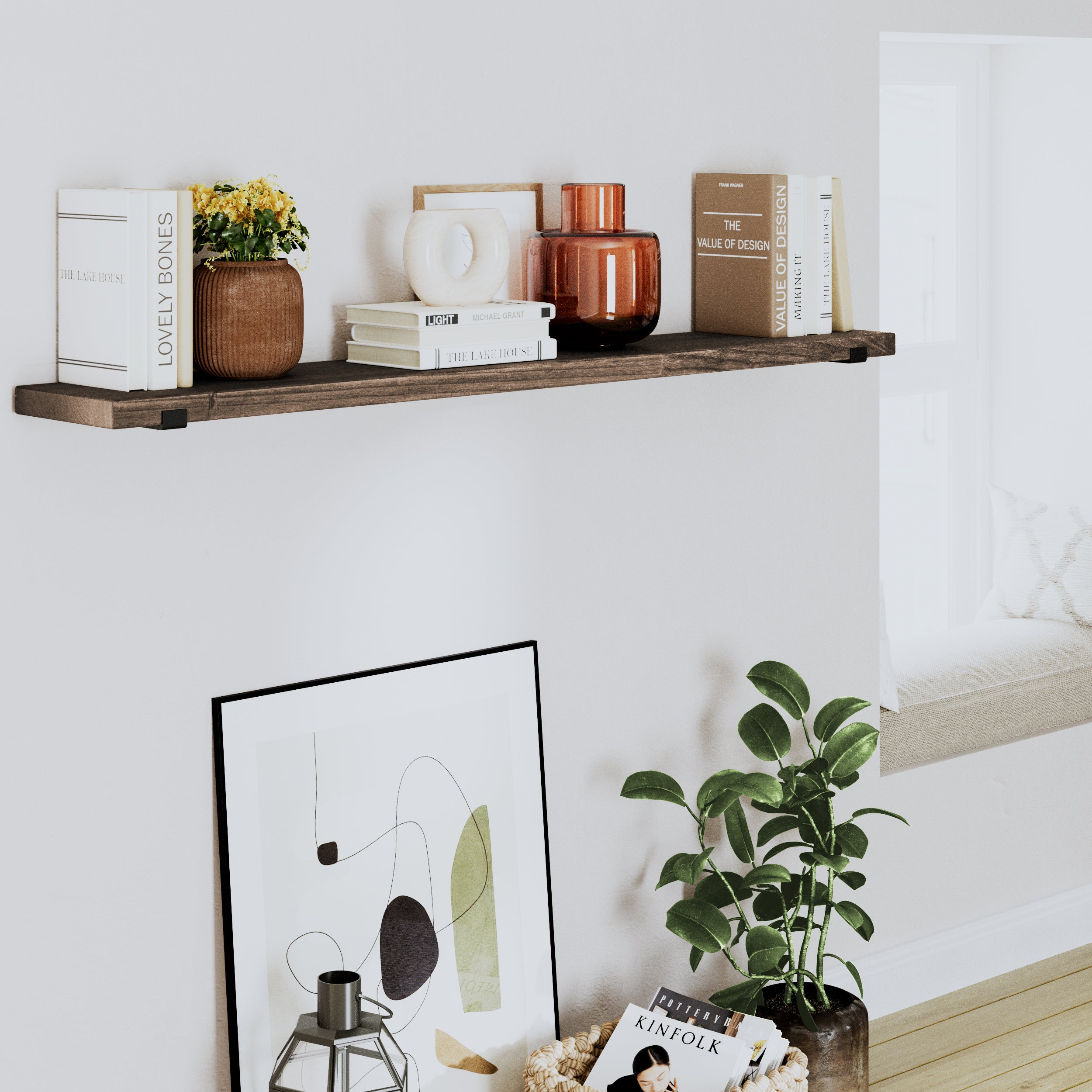 A dark walnut 60 inch floating shelf with books and vases, complemented by a green plant and modern decor.