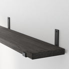 Ebony living room shelf with black L-shaped metal brackets, showing sturdy support and rustic wood grain for modern industrial charm.