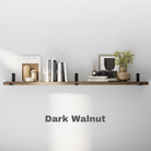 A single floating shelf in a rich Dark Walnut finish, mounted with black brackets and styled with books, ceramics, and a framed print for a modern, minimal look.