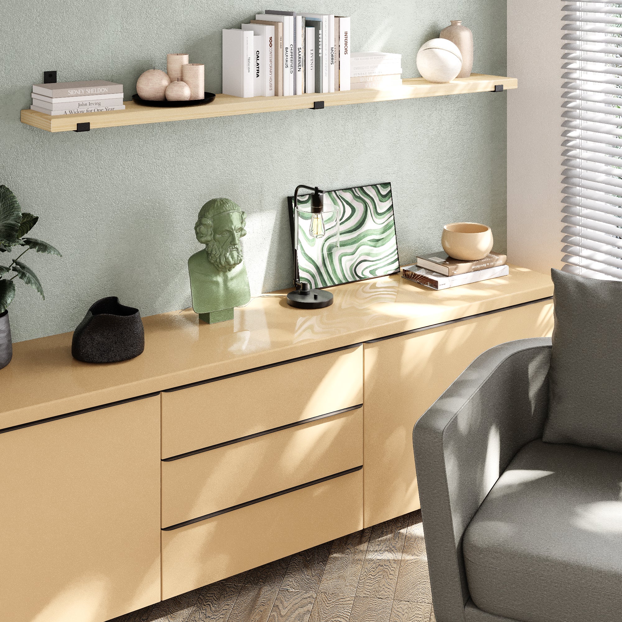 Single living room floating shelf over a muted green wall and beige cabinet creates a light, serene accent with books and minimalist décor under natural daylight.
