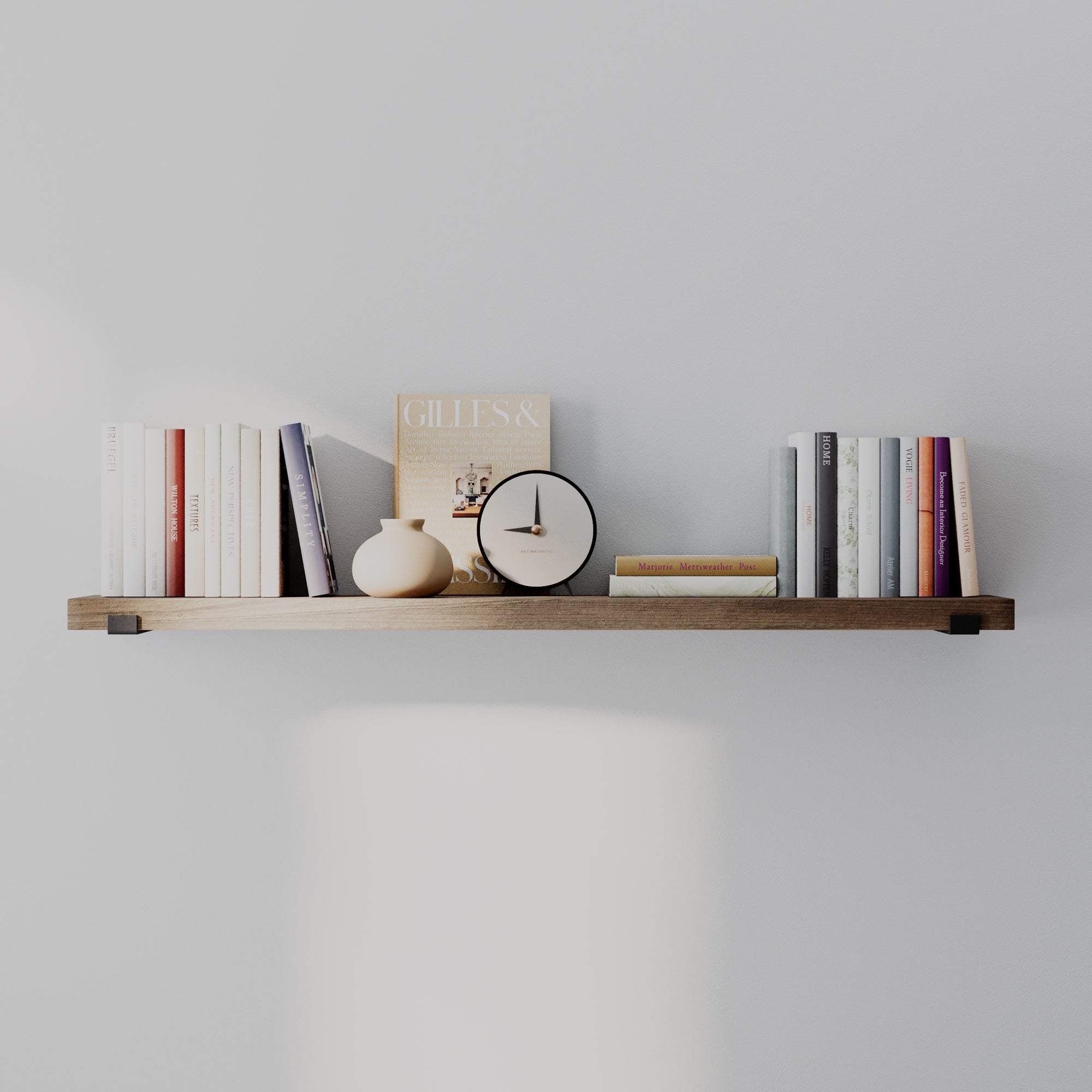 A long decorative shelf in a sleek provincial finish displaying books, a clock, and decorative objects. Balanced, minimalist styling emphasizes length and versatility for modern interiors.