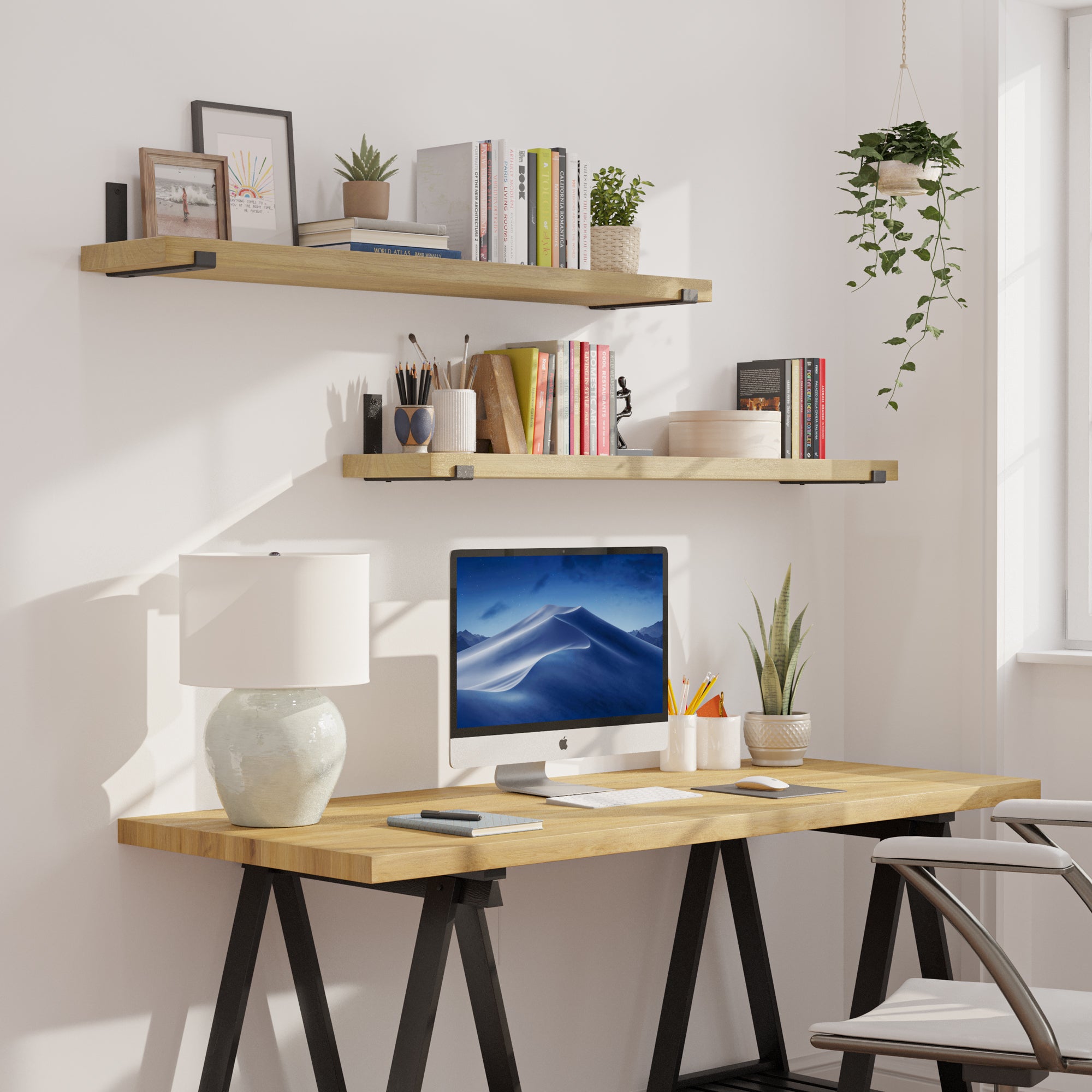 Two hanging shelves for office decor styled above a modern desk setup. Decorated with books, plants, and frames, showing practical storage and warm, contemporary workspace aesthetics.