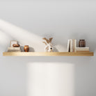 Minimalist 60 inch long wooden floating shelf styled with neutral books, vases, and décor. Highlights the natural white oak veneer finish and clean, seamless wall-mount design.