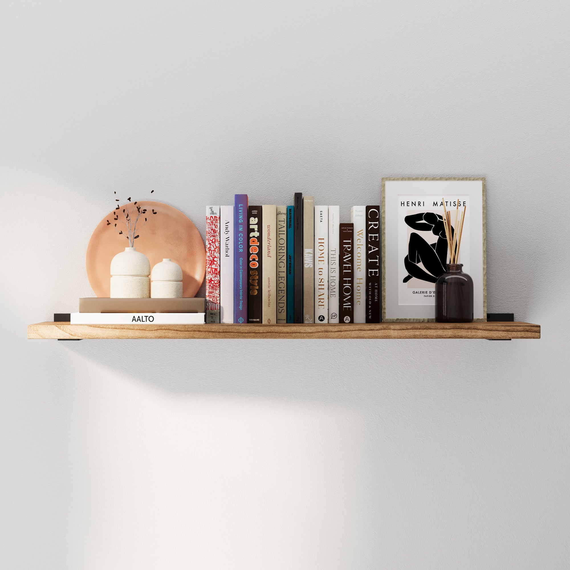 36 inch floating book shelf with a rich burnt finish, styled as a long wall shelf for books, framed art, and décor. This rustic floating shelf adds warm farmhouse charm to living room, bedroom, or office wall storage.