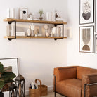 Image 6: PIPE 60'' Floating Pipe Shelves in a living room, adorned with books and minimalist decor.