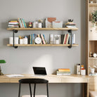 Hanging shelves 2 tier burnt color above a desk, filled with books, decor, and office supplies.