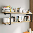 Close-up of 60 inch organizer shelves 2 tiered in an office, holding books, decor, and stationery.