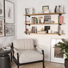 Industrial chic living room with PIPE 60'' Floating Pipe Shelves - 3 Tier - Burnt, stylishly showcasing books and decor.