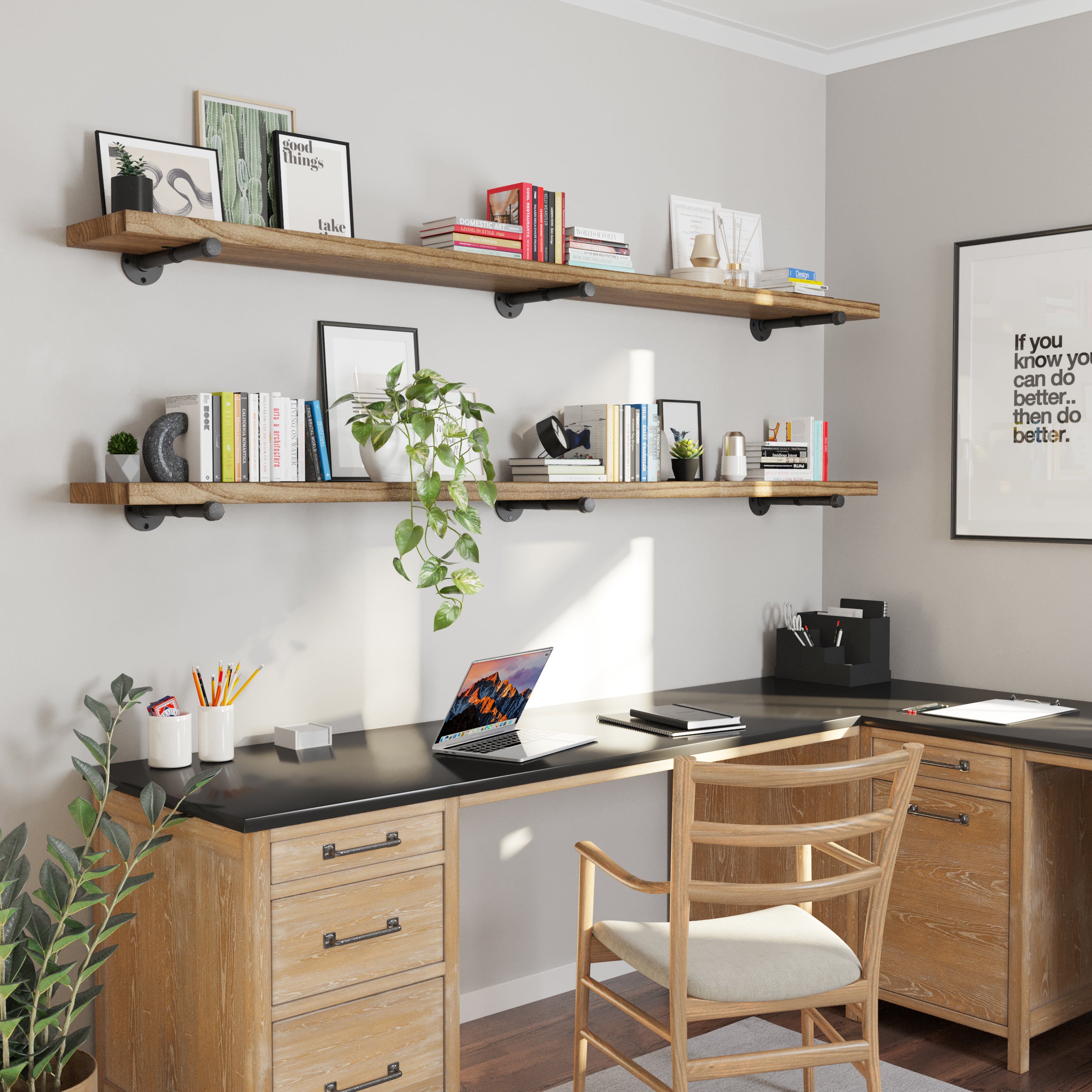 A home office with dual long wooden shelves above a black desk, decorated with books, plants, and minimalist art, creating a productive and aesthetic workspace.