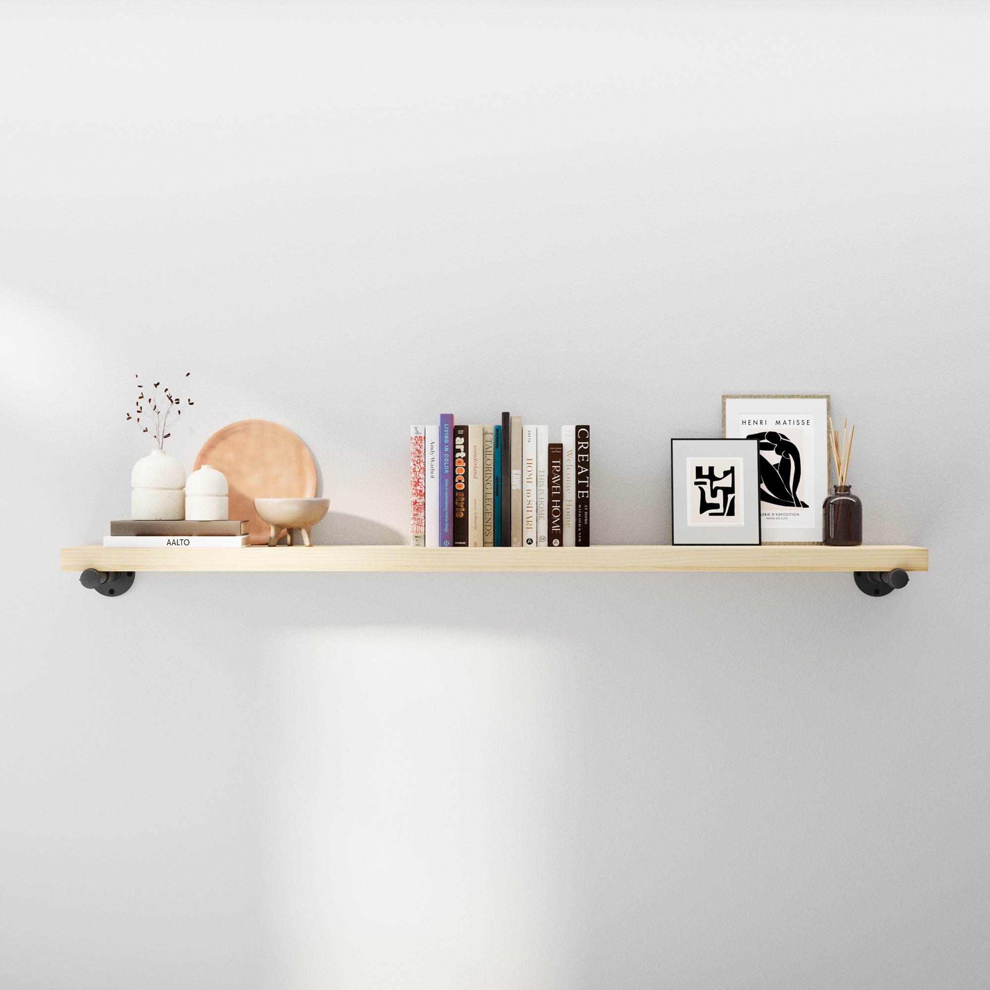 60 inch floating shelf styled with books and décor, featuring a light wood finish and industrial pipe brackets. A rustic wall shelf for living room décor, farmhouse storage, kitchen organization, or modern wall mounted bookshelf.