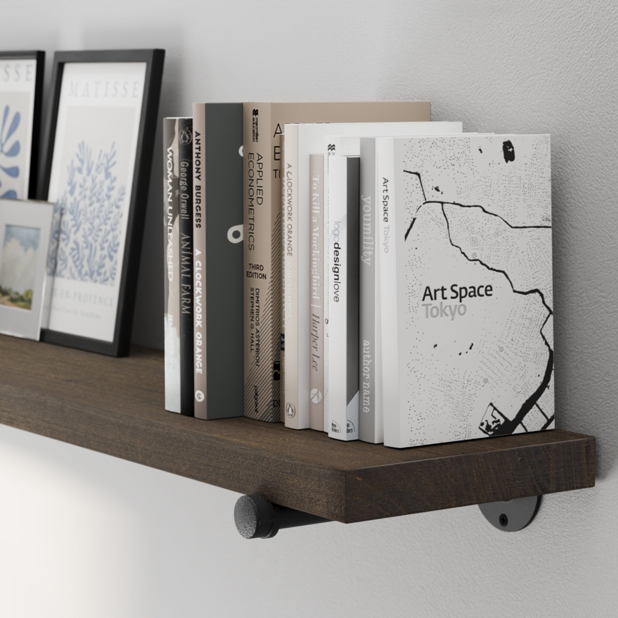 A 72” dark walnut wall shelf showcasing rich wood grain and sturdy black industrial pipe brackets. A long wood shelf for displaying books, framed art, collectibles, and decorative accents with farmhouse appeal.