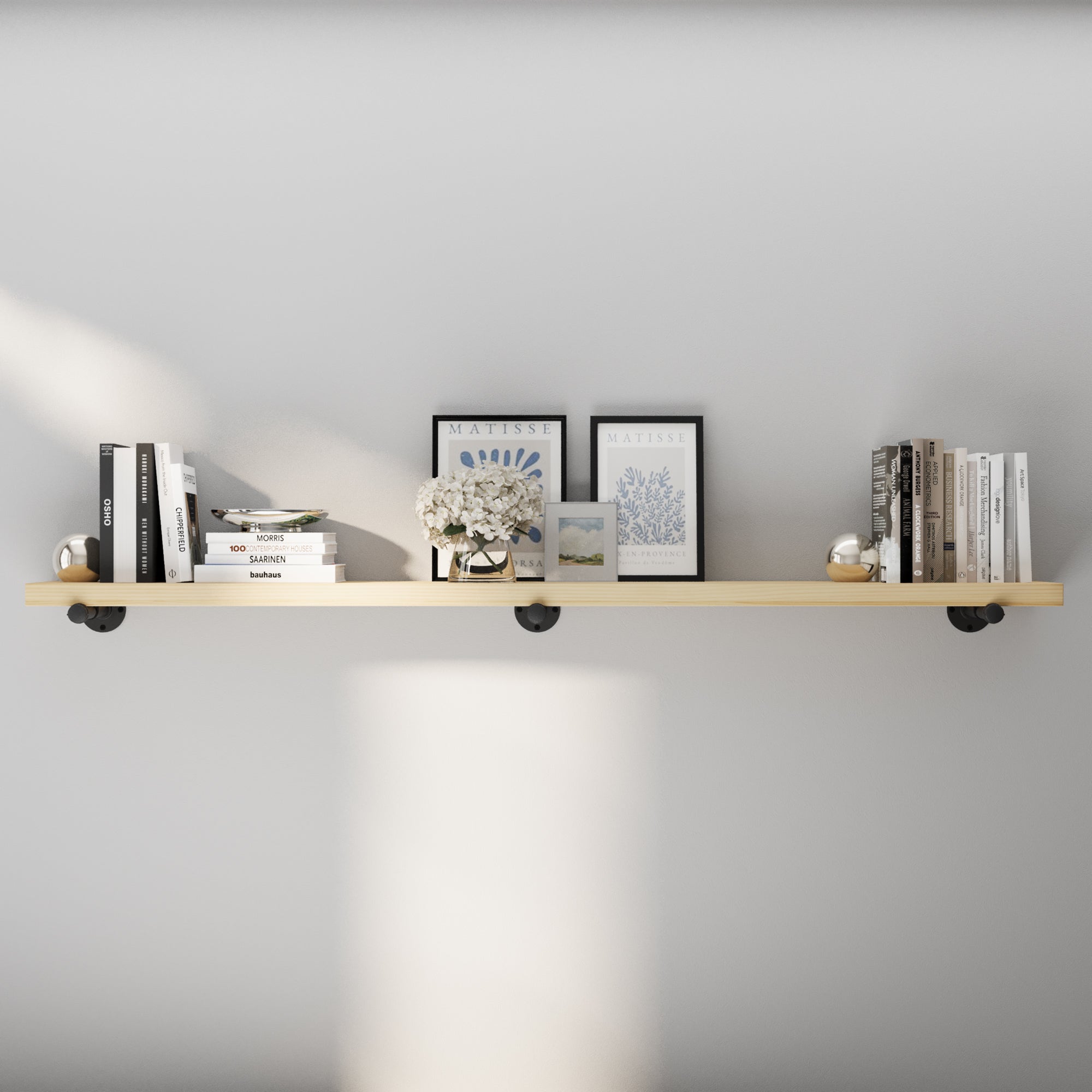 72 inch industrial pipe shelf with a natural sanded wood surface, sanded smooth for a clean organic look. This extra long wall shelf pairs black pipe brackets with minimalist décor for rustic, Scandinavian, farmhouse, or modern interiors.