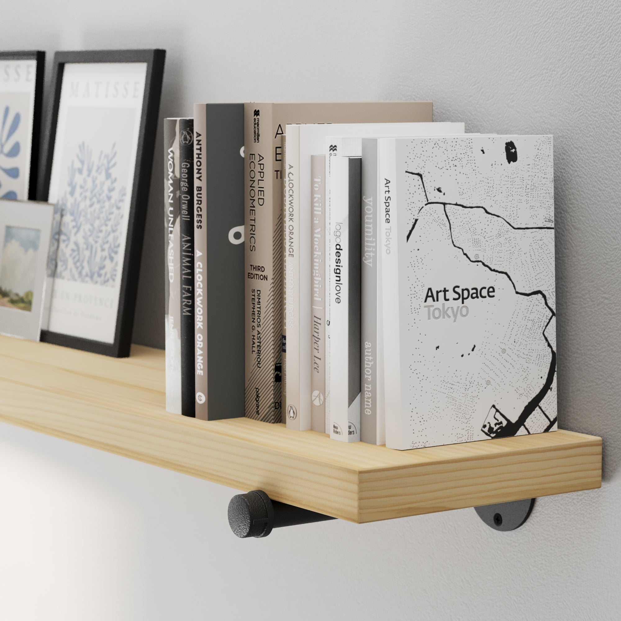 A 72” wall mounted long shelf featuring natural no-finish wood, hand-sanded for a raw and authentic texture. A long wall-mounted bookshelf for displaying décor, framed art, books, and modern farmhouse accents