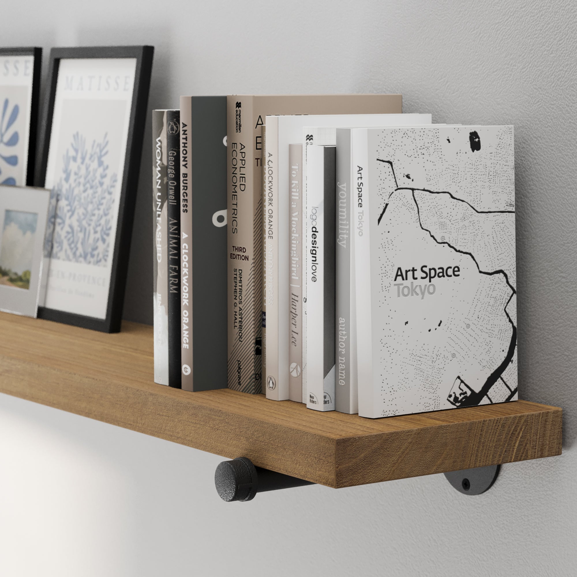 A 72” long floating book shelf featuring a rich golden oak finish with visible wood grain. A long wall-mounted bookshelf with sturdy black pipe brackets, ideal for farmhouse, modern, or industrial décor.