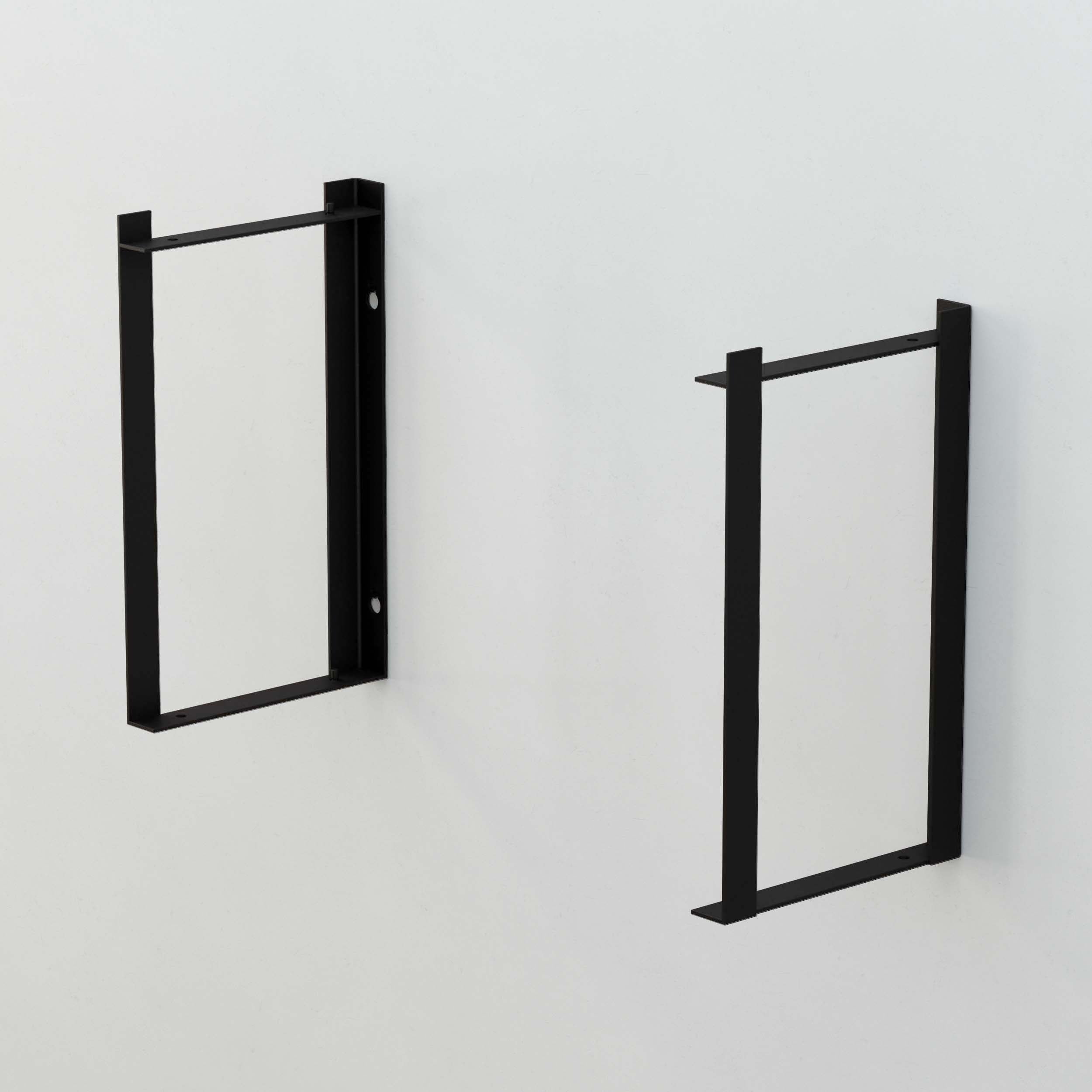Two black rectangular shelf brackets mounted on a wall without shelves.