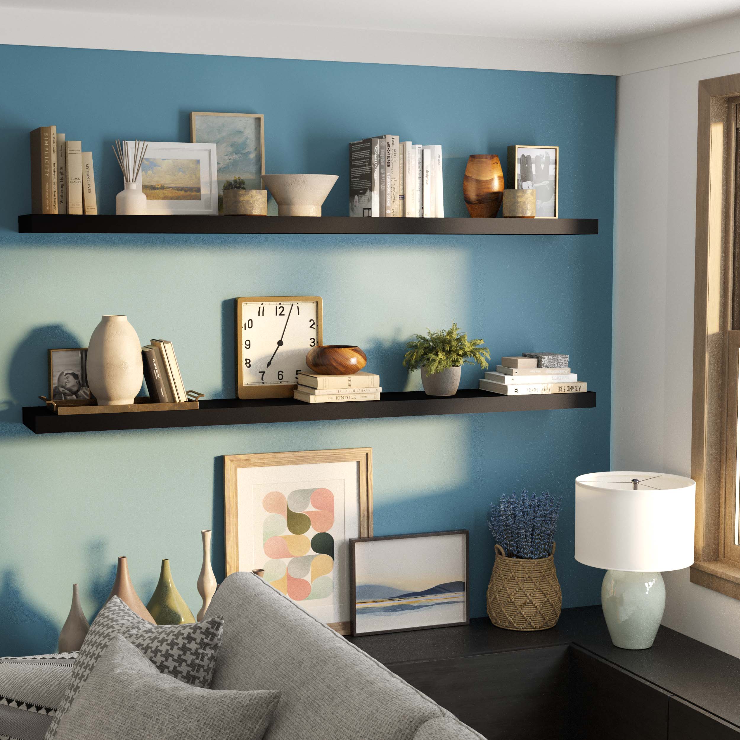 Two black long shelves arranged on a blue wall, adorned with vases, books, and a clock, perfect for a modern living room setup.