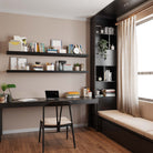 A stylish home office with two black shelves with invisible bracket holding books, files, and decor, enhancing the workspace with a clean, modern aesthetic that is both functional and elegant.