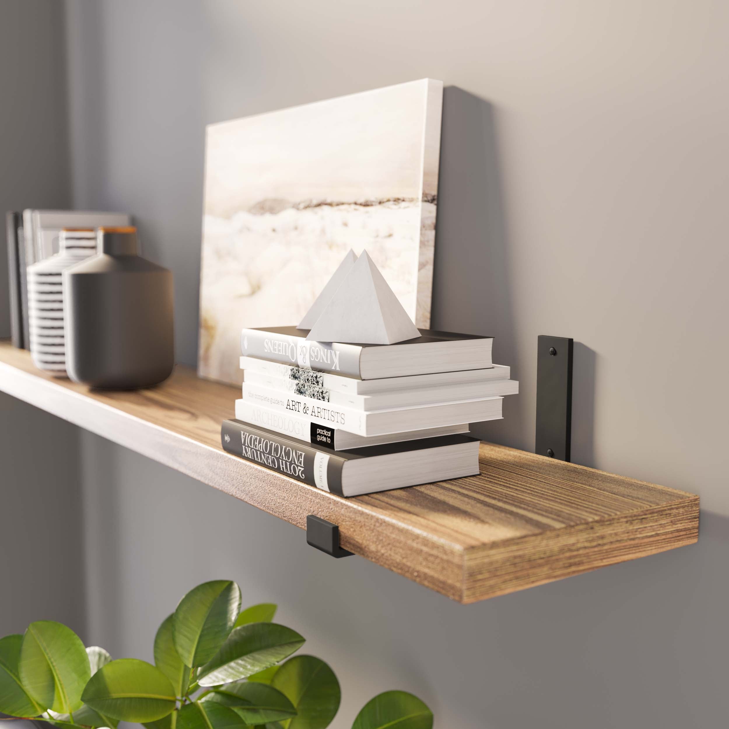 A stylish floating wood bookshelf supported with black metal L shaped industrial brackets against a gray wall.