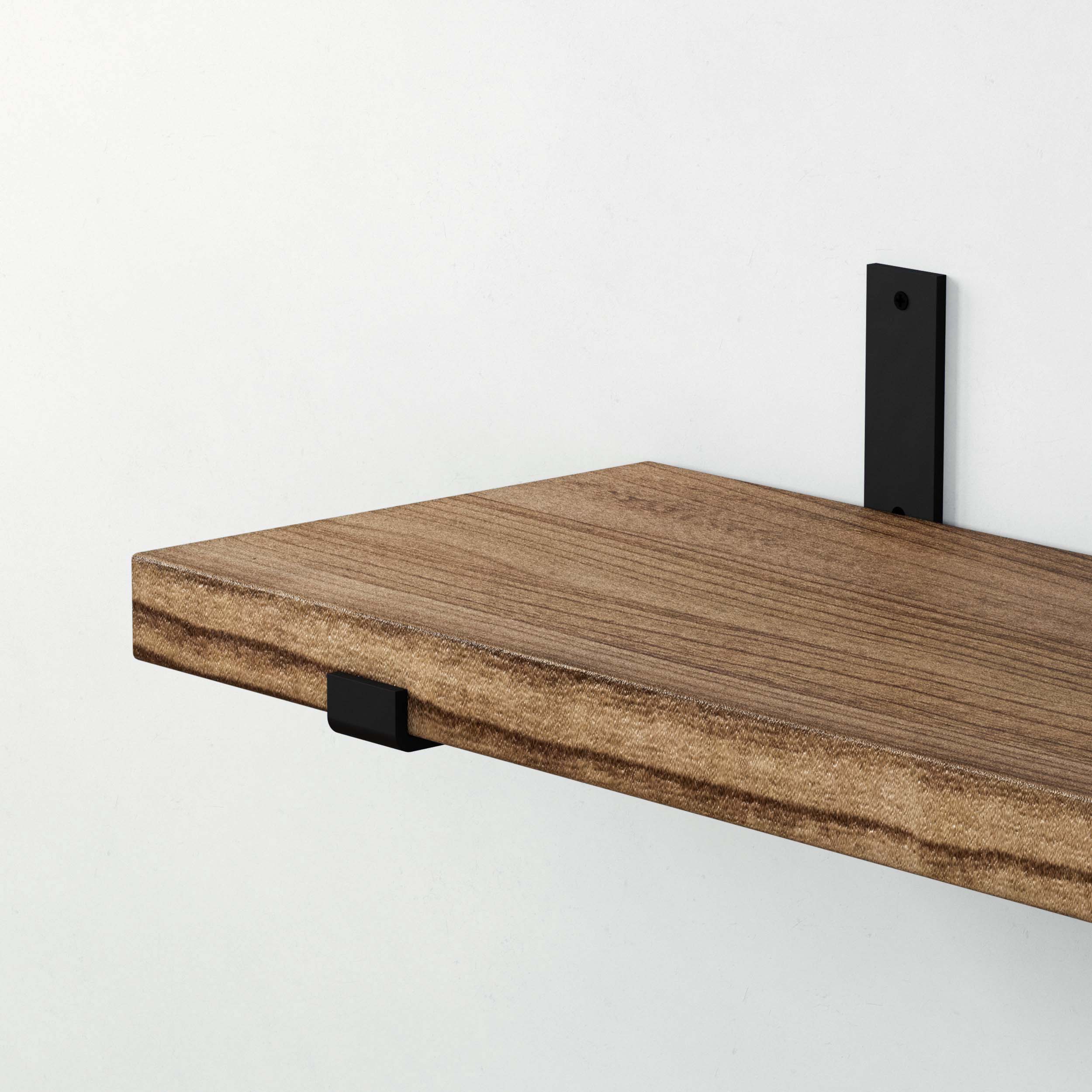 Close-up of a wooden shelf supported by a black rectangular shelf bracket.