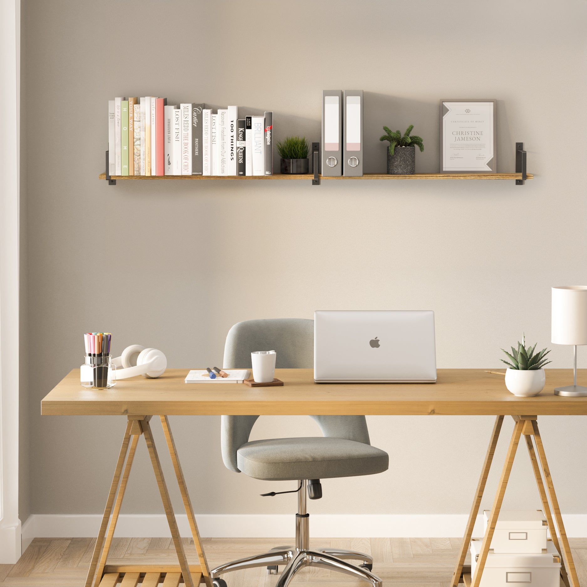 Mounted above a modern work desk, office shelf offers smart organization for office folders, books, and plants. The setup blends functionality with style, ideal for home offices.