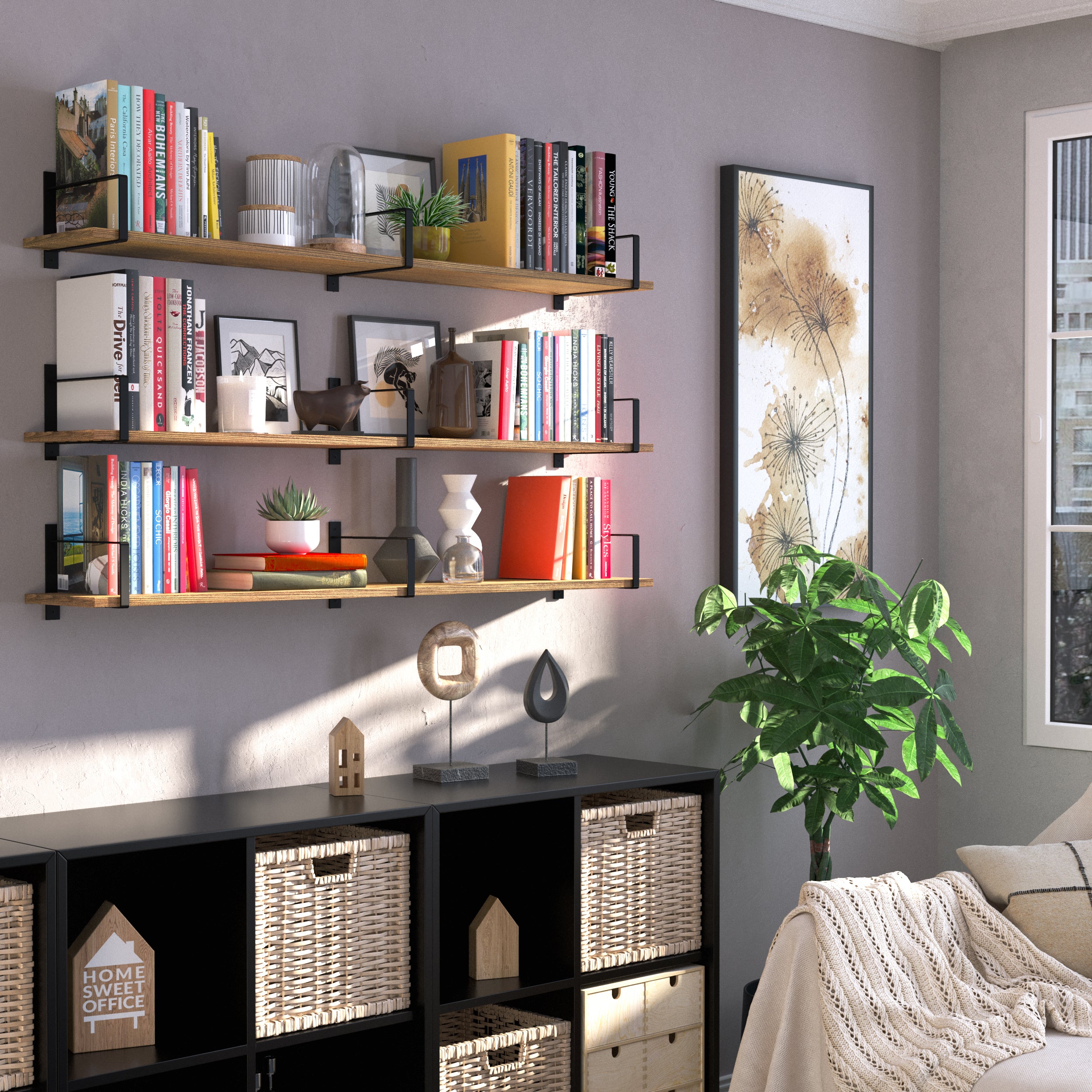 A cozy reading nook with three hanging shelves for living room above a black storage unit, adorned with books, framed art, plants, and stylish décor, creating a warm and inviting ambiance.