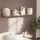 A single living room shelf with black metal side guards, decorated with neutral books, dried florals, and minimalist decor, set against a soft beige wall.