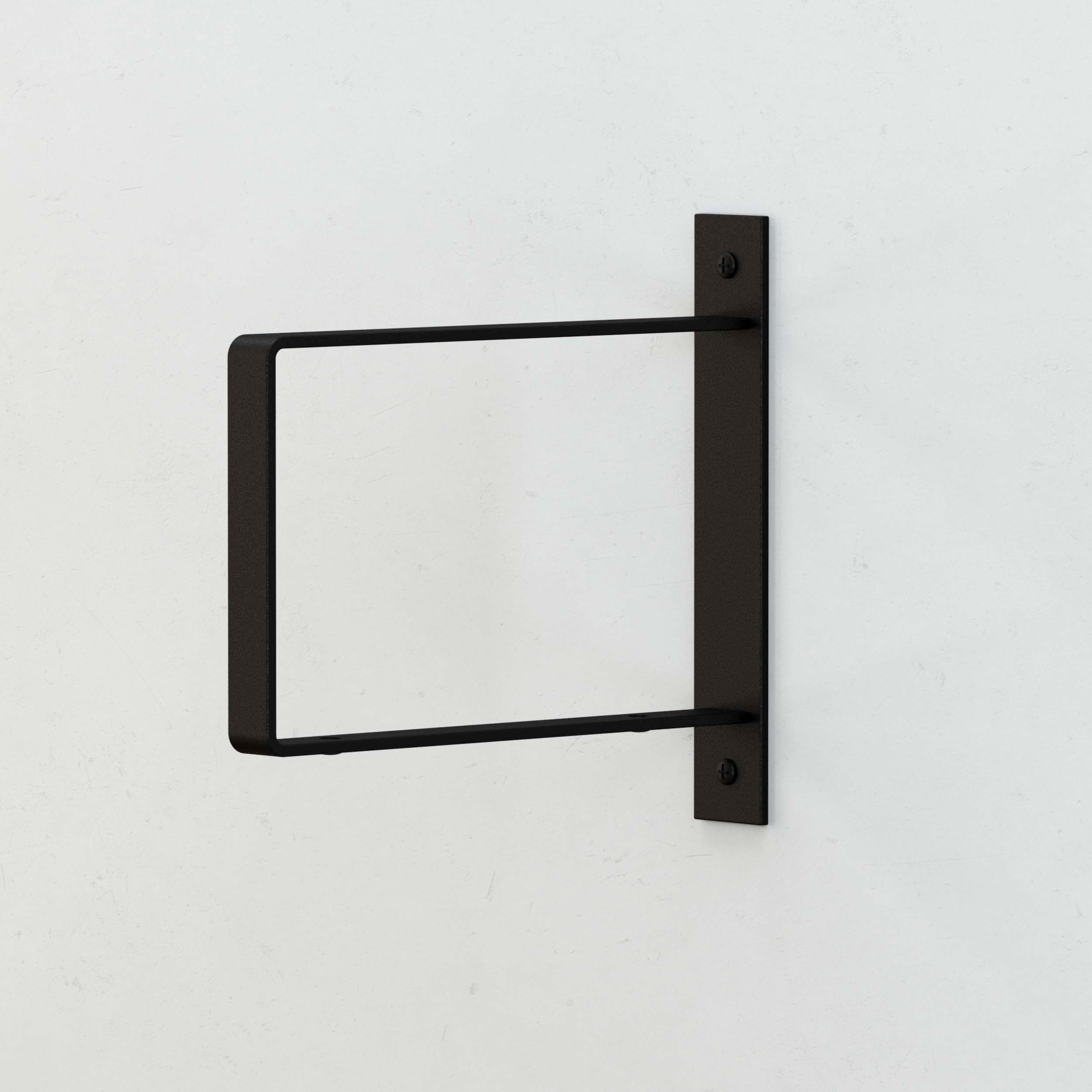 Black rectangular wood shelf bracket mounted on a wall without a shelf.