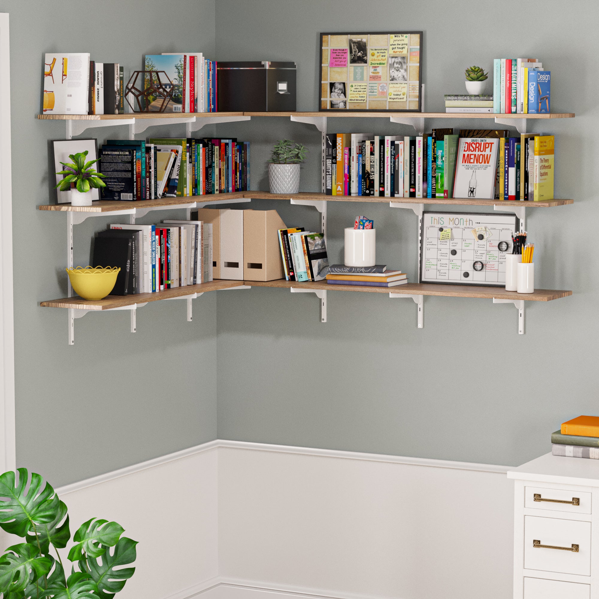 3 tiered corner wall shelf with books, plants, and decorative items against a gray wall.