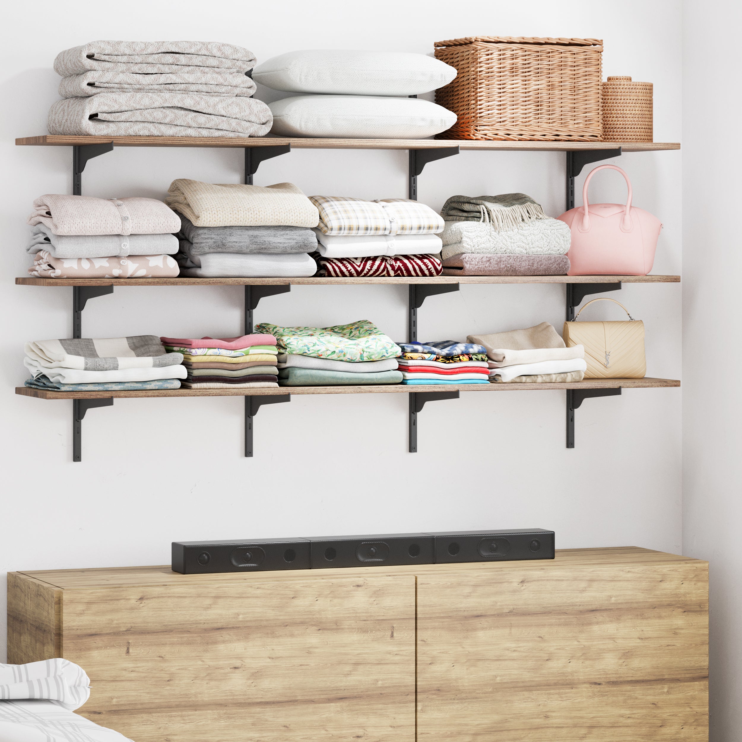 Shelving unit adorned with books, plants, and decorative items, featuring wooden shelves and black rails.
